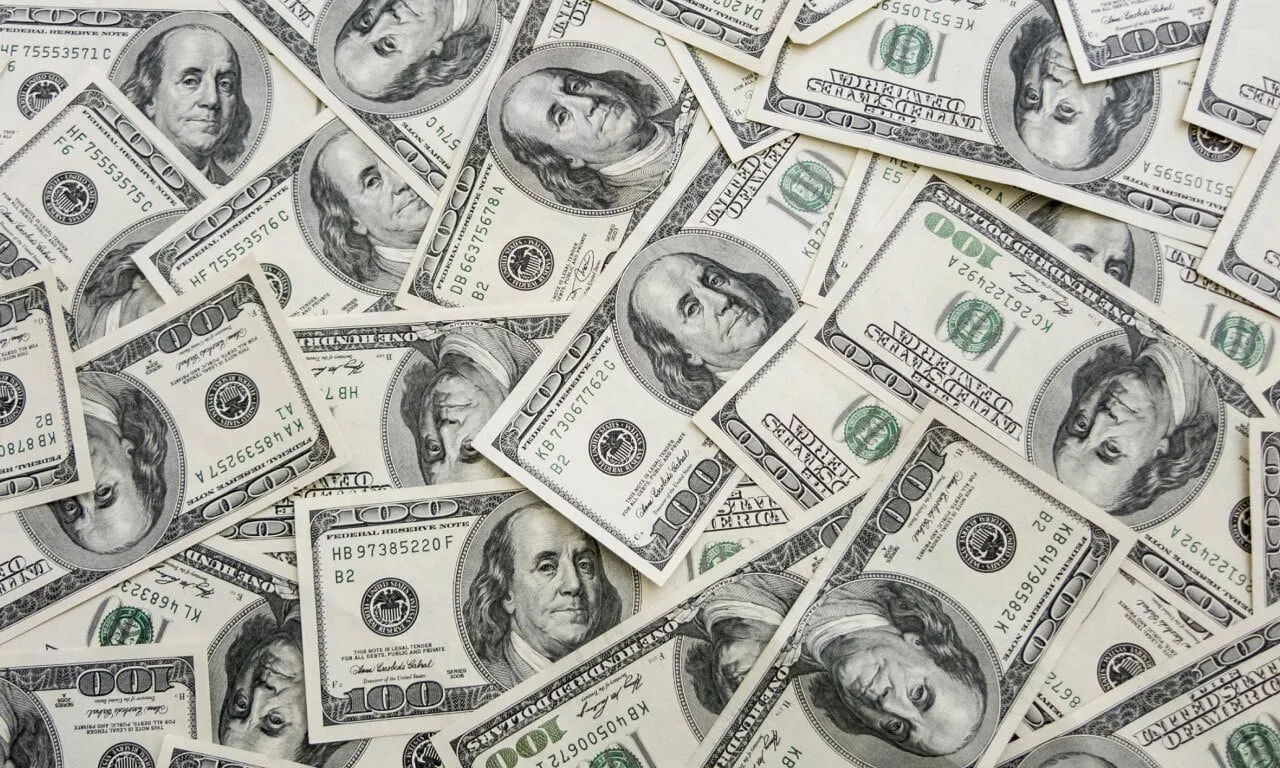 一堆百元大鈔，象徵著交易中潛在的利潤和機會。