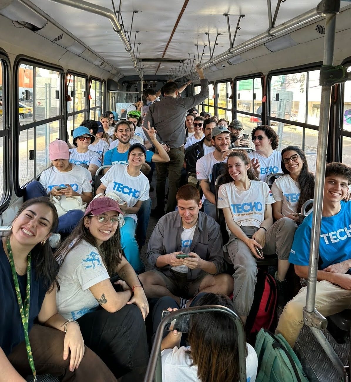 Deriv Asunción and TECHO employees on a bus trip to Areguá.