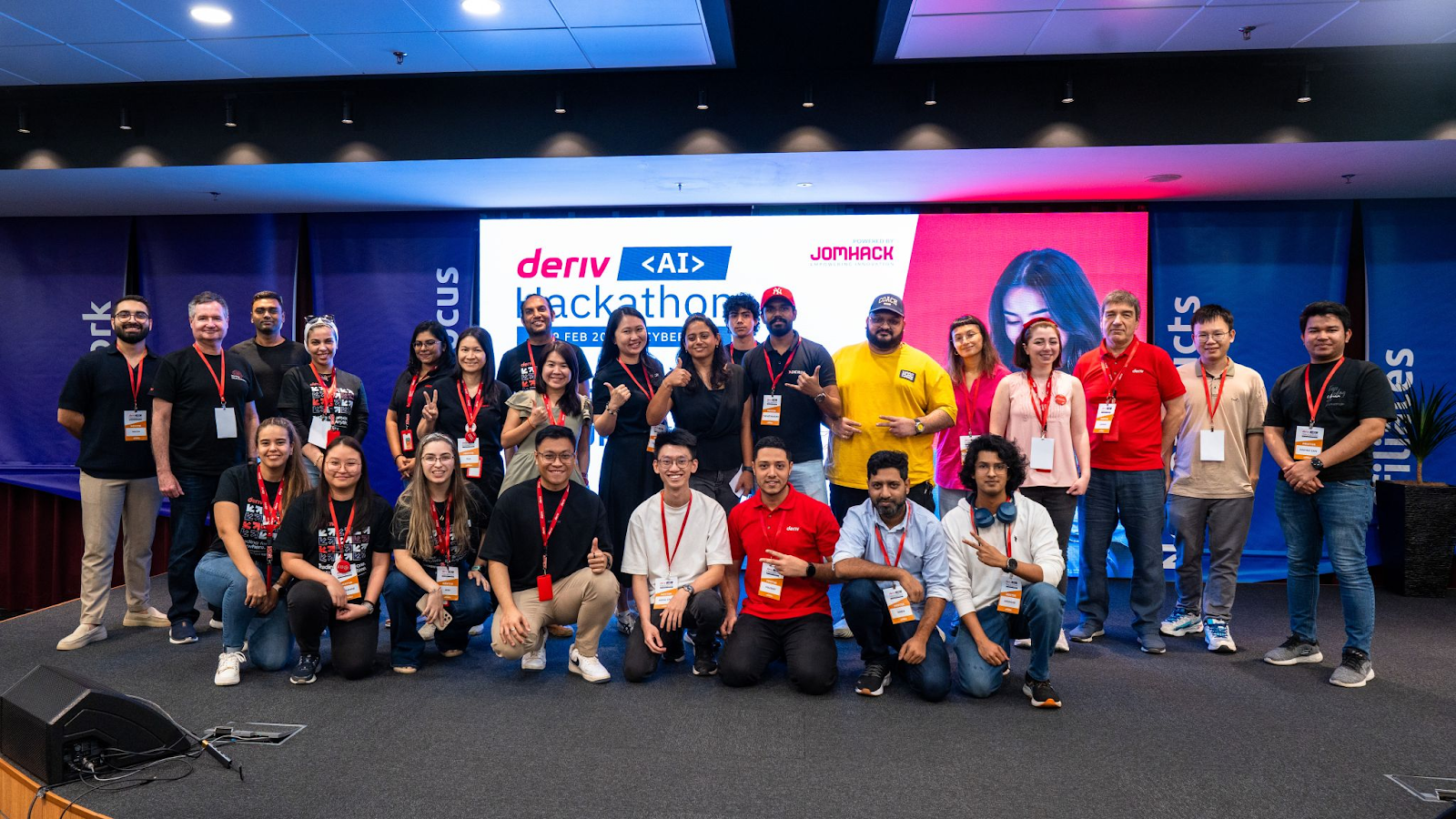 Group photo from the second Deriv AI Hackathon held in 2025 with the participants and organizers on stage.